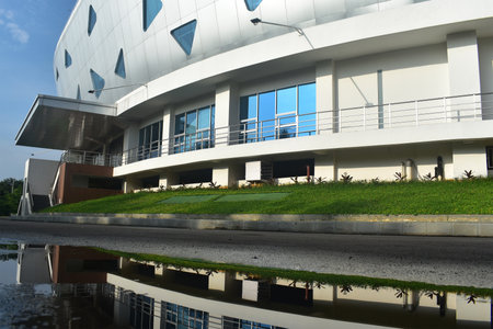 Modern multi purpose building with a reflection in the waterの写真素材