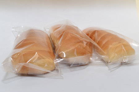 Bread in plastic bag on white background,の写真素材