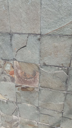 Background of natural stone tiled wallの写真素材