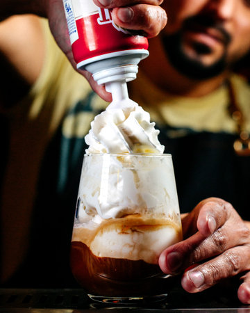 front view bartender preparing a dessert with whipped cream