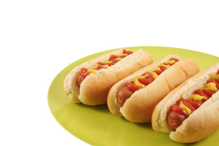 Three Hotdogs on a green plateの写真素材