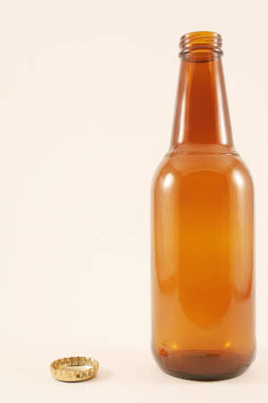 Unlabeled Beer bottle with cap besides and room for textの写真素材