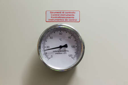 immersion thermometer on the tank
