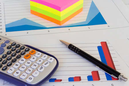 An office desk with charts and histograms graphical documents