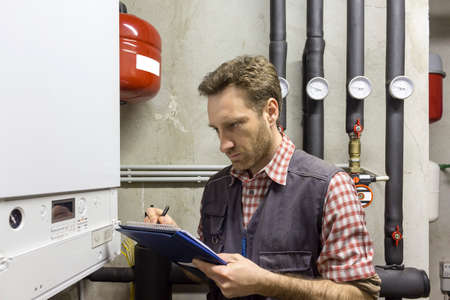 plumber who carries out the maintenance of a condensing boilerの写真素材