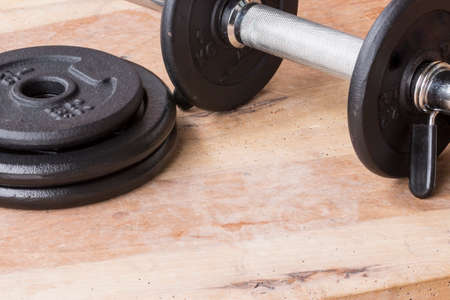 Weights and dumbbell set for fitness  on a wooden backgroundの写真素材