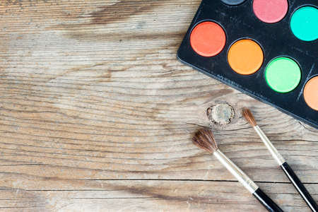 close-up of watercolors and brushes on wooden backgroundの写真素材