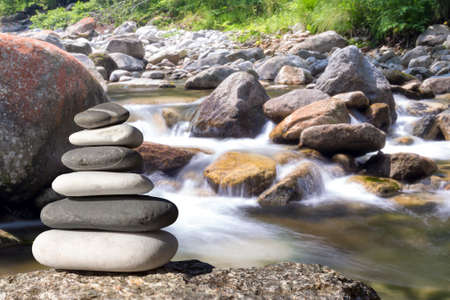 Close up of zen stones with background the garden and the lakeの写真素材