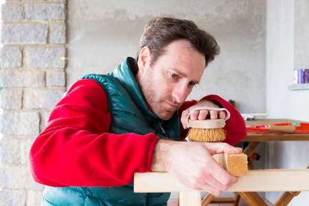 Young Carpenter at work building a wooden frameの写真素材