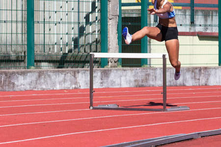 young female athlete running the obstacle courseの写真素材