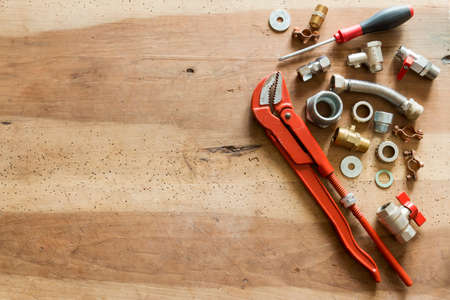 plumber  tools and fittings on wooden backgroundの写真素材