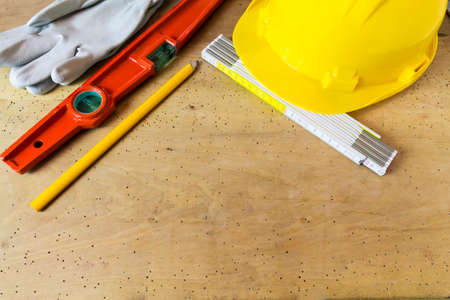 Protective helmet and mason tools on wood backgroundの写真素材