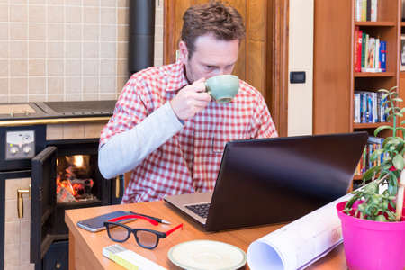 Young man works remotely through internet connectionの写真素材