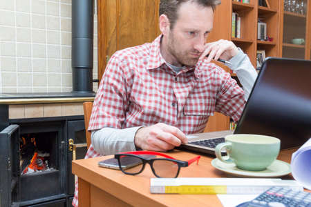 Young man works remotely through internet connectionの写真素材