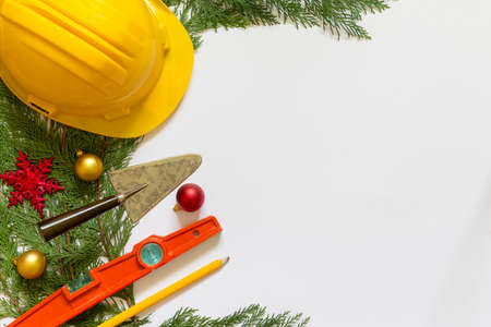Protective helmet, mason tools  and Christmas decorations on  white backgroundの写真素材