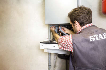 plumber repairing a condensing boilerの写真素材