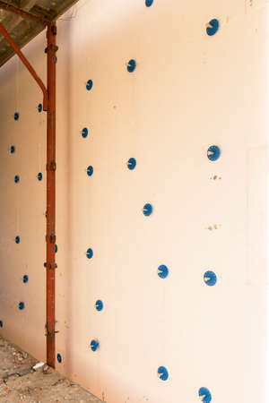 Installation of outer coat insulating on a residential homeの写真素材