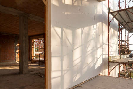 Installation of outer coat insulating on a residential homeの写真素材