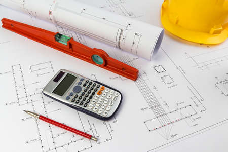 Building design: Office desk with project drawingsの写真素材