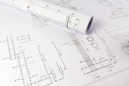Building design: Office desk with project drawingsの写真素材