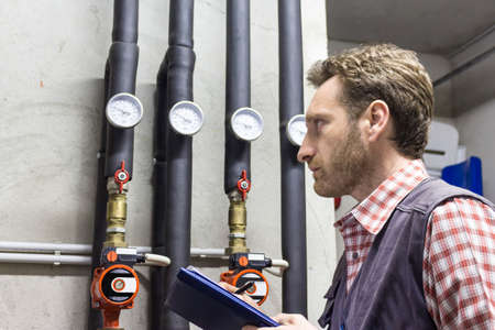plumber at work making the consumption meteringの写真素材