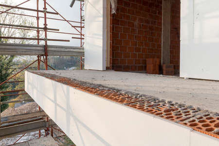 Installation of outer coat insulating on a residential homeの写真素材