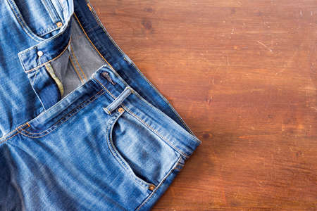 Close up of jeans pants on wooden backgroundの写真素材