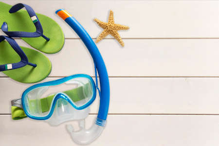 Sea slippers, scuba mask  and starfish on wooden backgroundの写真素材