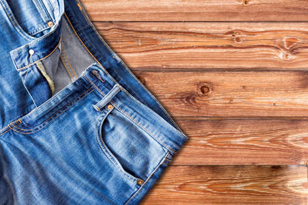Close up of jeans pants on wooden backgroundの写真素材