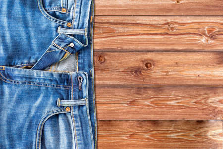 Close up of jeans pants on wooden backgroundの写真素材