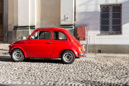 Red vintage italian car parked in the city centerの写真素材