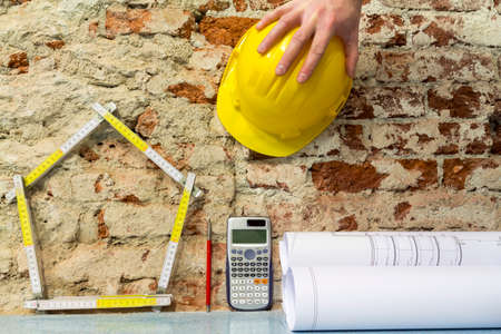 Construction of buildings: house and projects on brick wall backgroundの写真素材