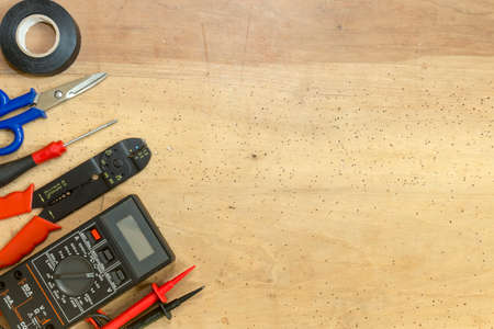 Electrician tools, components and instruments  on a wooden backgroundの写真素材