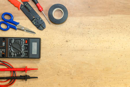 Electrician tools, components and instruments  on a wooden backgroundの写真素材