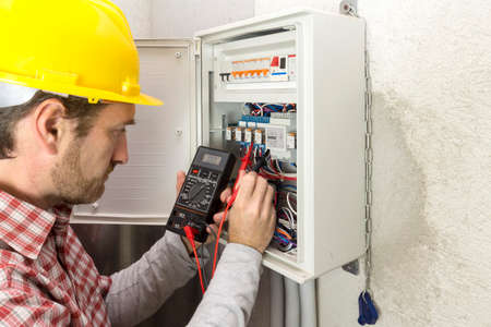 electrician at work measures the electric currentの写真素材