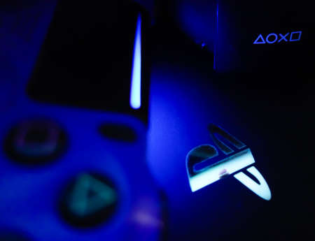 Sony Playstation logo illuminated on blue light from game controller