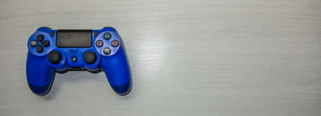 Sony Playstation blue game controller in a gray textured backgroundのeditorial素材