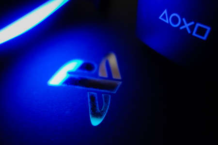 Sony Playstation logo illuminated on blue light from game controllerのeditorial素材