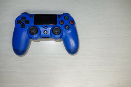 Sony Playstation blue game controller in a gray textured background