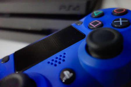 Sony black Playstation 4 Pro game console and blue wireless controller. PS4 symbolのeditorial素材