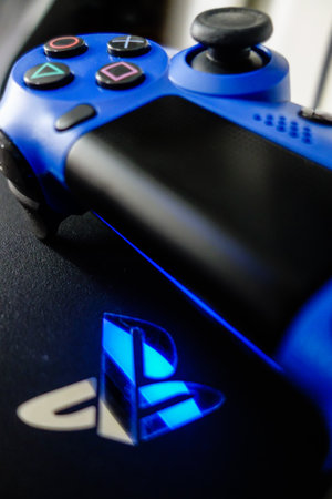 Sony Playstation logo illuminated on blue light from game controller