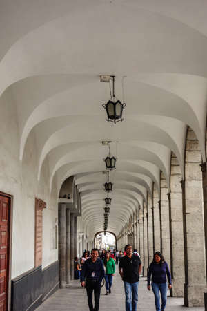 Arequipa, Peru: people walking through the architectural Archs and corridor of main plazaのeditorial素材