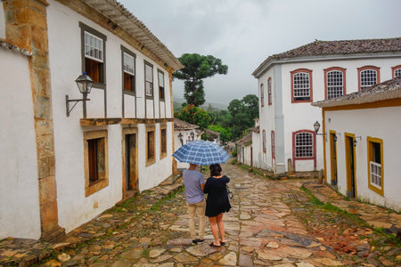 couple walking on streets of Tiradentes historic city, in Minas Gerais, Brazil.のeditorial素材