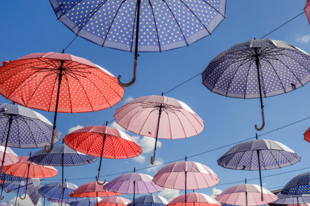 Colorful umbrellas decoration against blue sky. low angle view