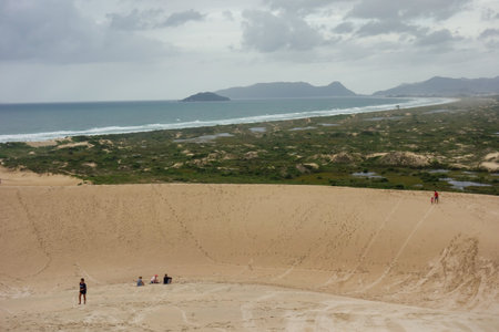 tourists at Dunes of Joaquina, in Florianopolis, Santa Catarina, Brazil.の写真素材