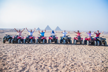 Tourism holidy sport activity, desert safary ride on off road 4x4 buggy bike, joyful happy people enjoy extreme fun time, shot selective focus with sahllow depth of field, Cairo Egypt on 15 june 2015のeditorial素材