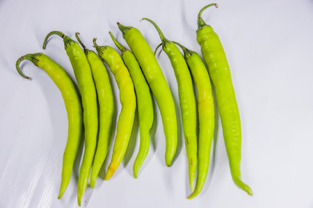 organic hot green peppers adding some heat to culinary creations. fiery kick, robust flavor, and...