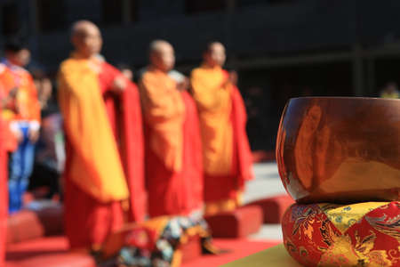 buddhist monk with bronze meditation gong.の写真素材