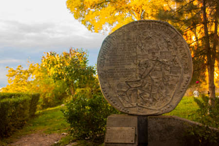Old stone gravestone in the park in the rays of the setting sunの写真素材