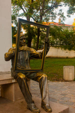 Sculpture of a man with a frame in his hands.の写真素材